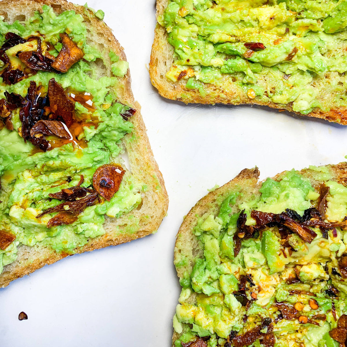 Avocado toast with caramelized onions on a white background