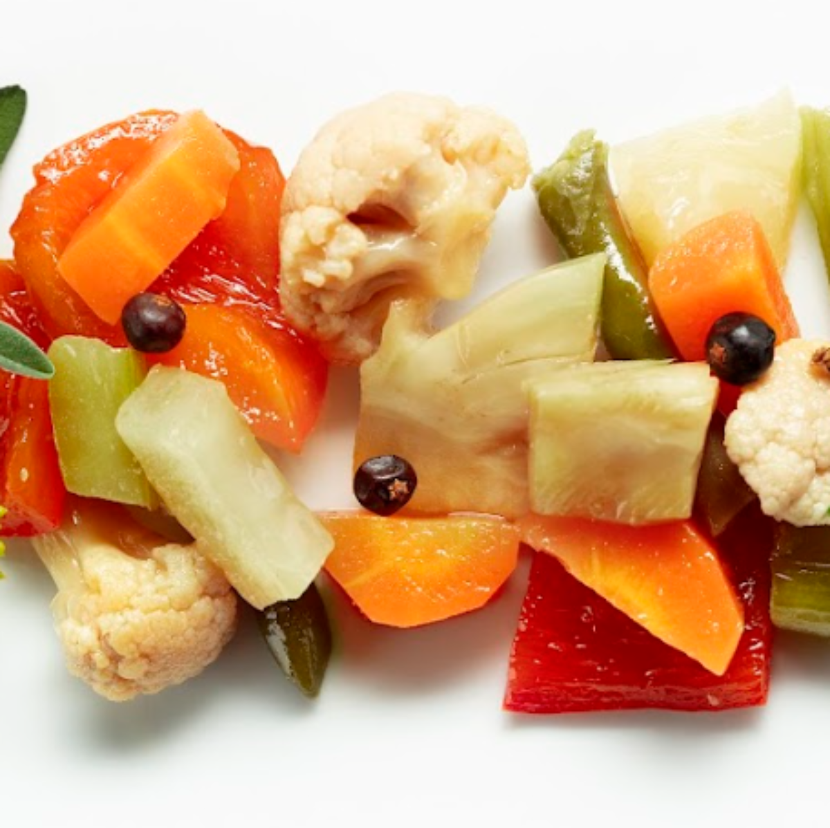 Colorful fruit salad with gummy bears on a white background