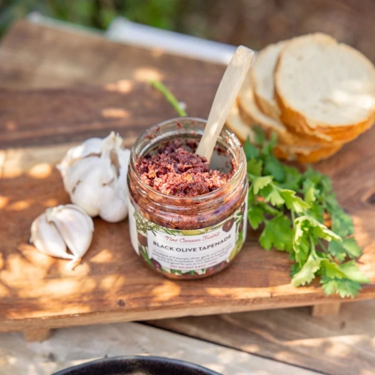 a jar of opened black olive tapenade