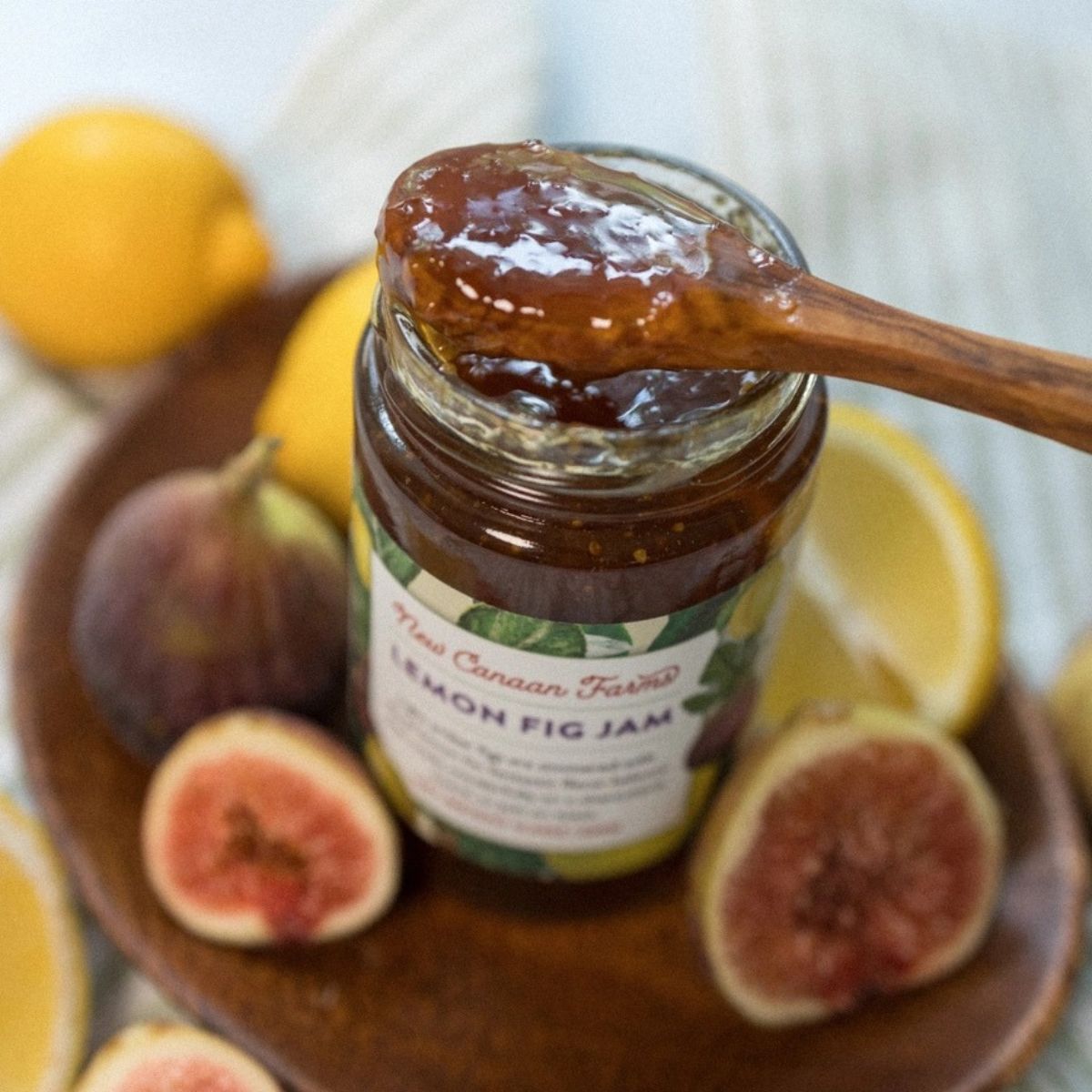 a open jar of lemon fig jam with a spoon with jam