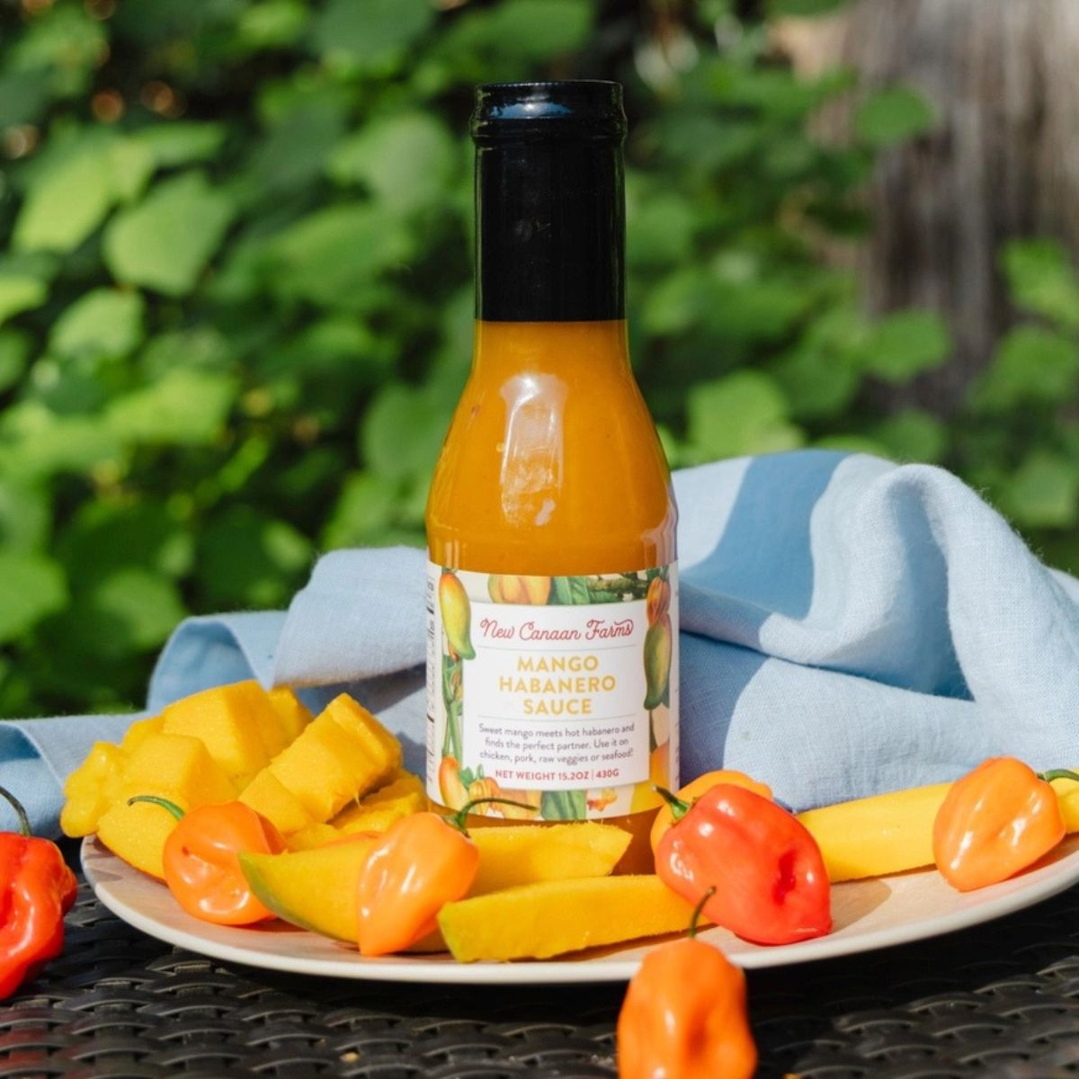 a jar of sauce with mangos and peppers