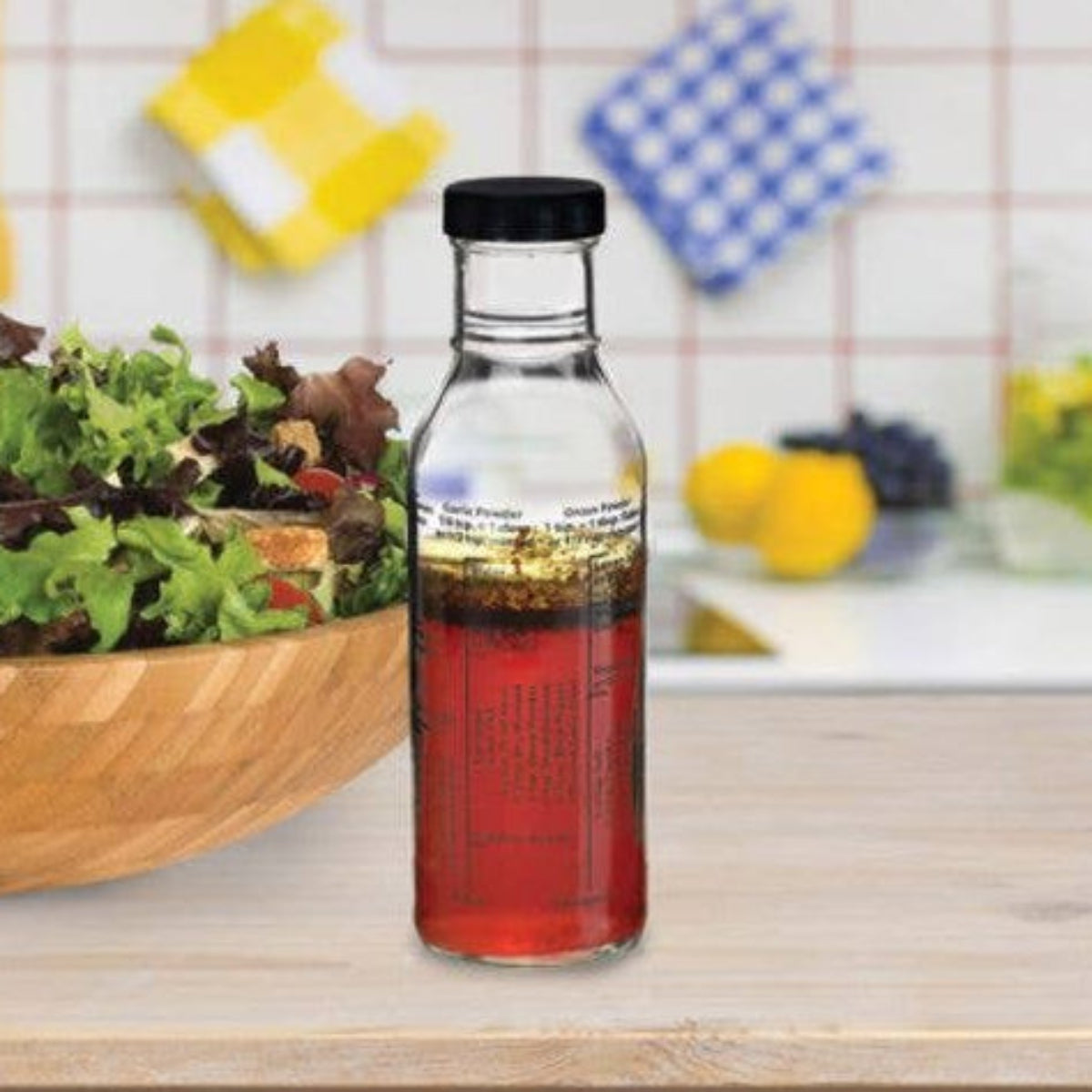 Bottle of salad dressing next to a bowl of salad on a kitchen counter