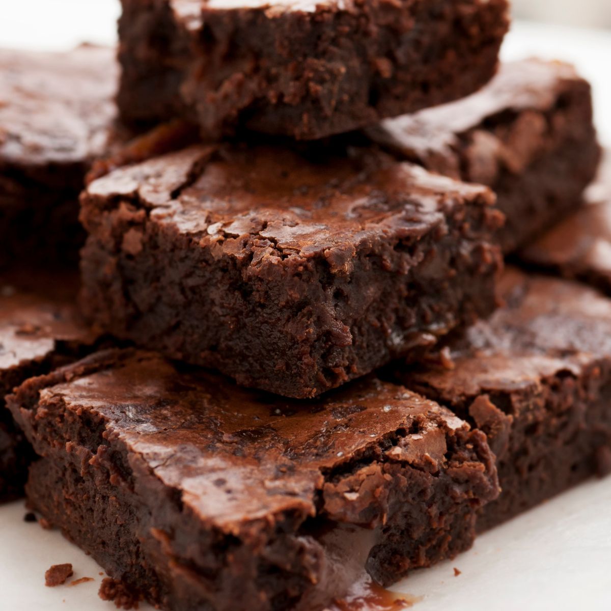 Stack of brownies on a white surface