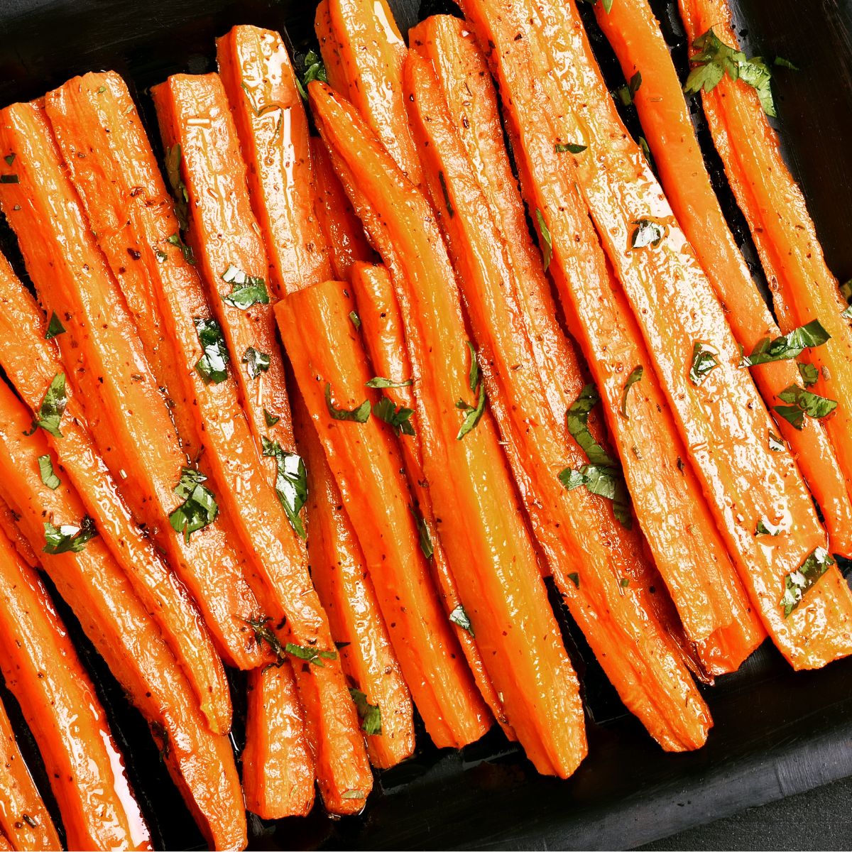 Roasted carrots with herbs on a baking tray