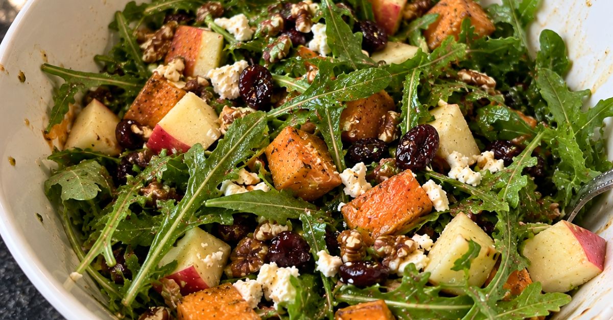 An easy roasted sweet potato and apple salad with goat cheese, pecans, dried cranberries and a Blood Orange Cranberry Pear vinaigrette.