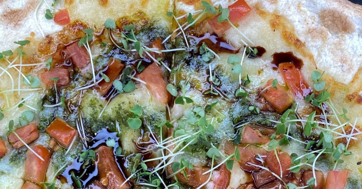 Pizza With Pesto, Mozzarella, And Arugula Microgreens
