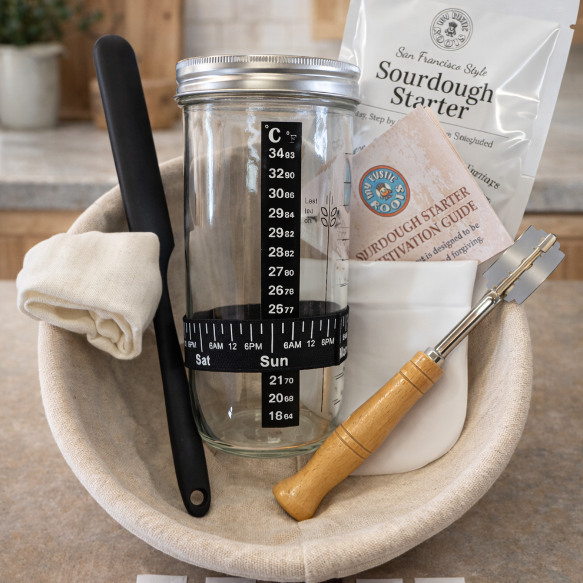 Bowl with a glass container, black knife, white paper, and wooden tool on a wooden surface.