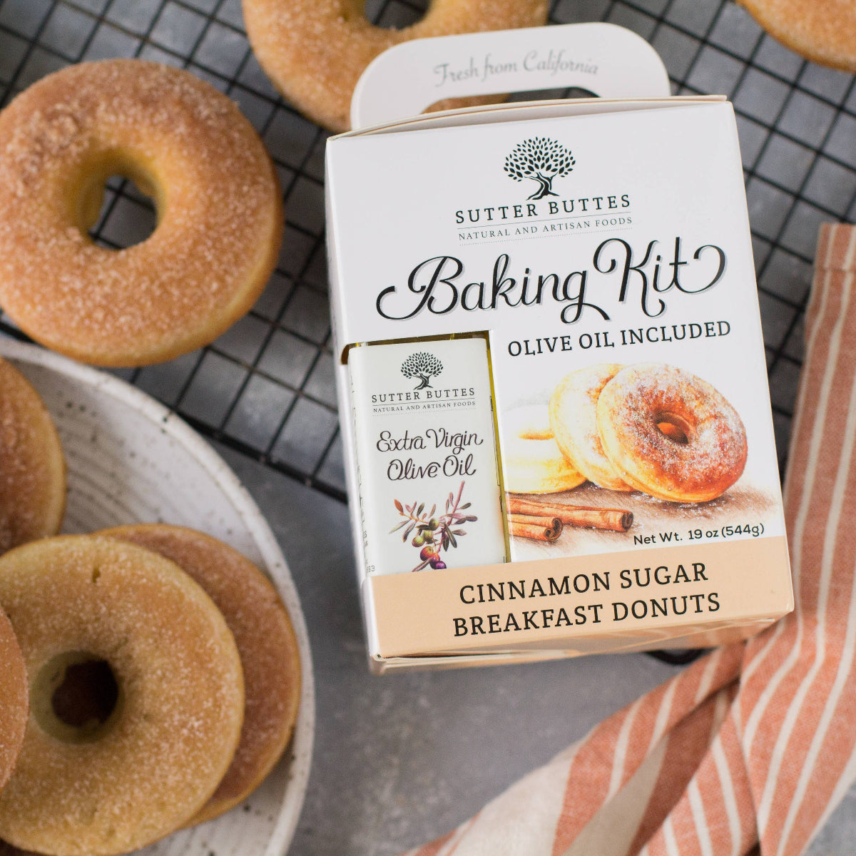 Cinnamon sugar donuts on a plate with a Sutter Buttes Baking Kit in the background.