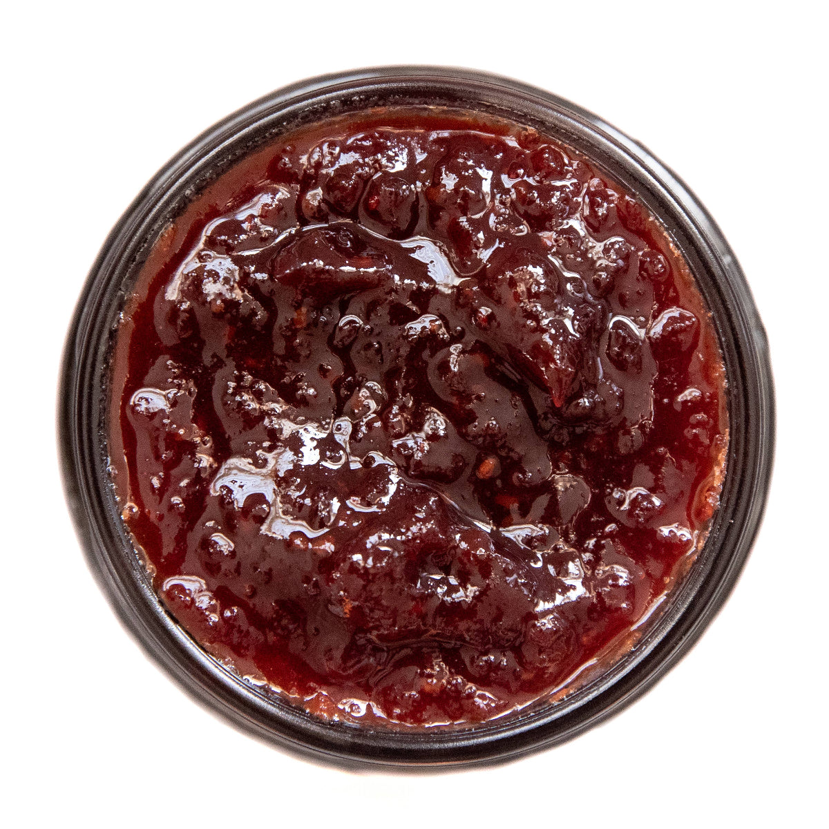 Close-up of a jar of red jelly or jam on a white background