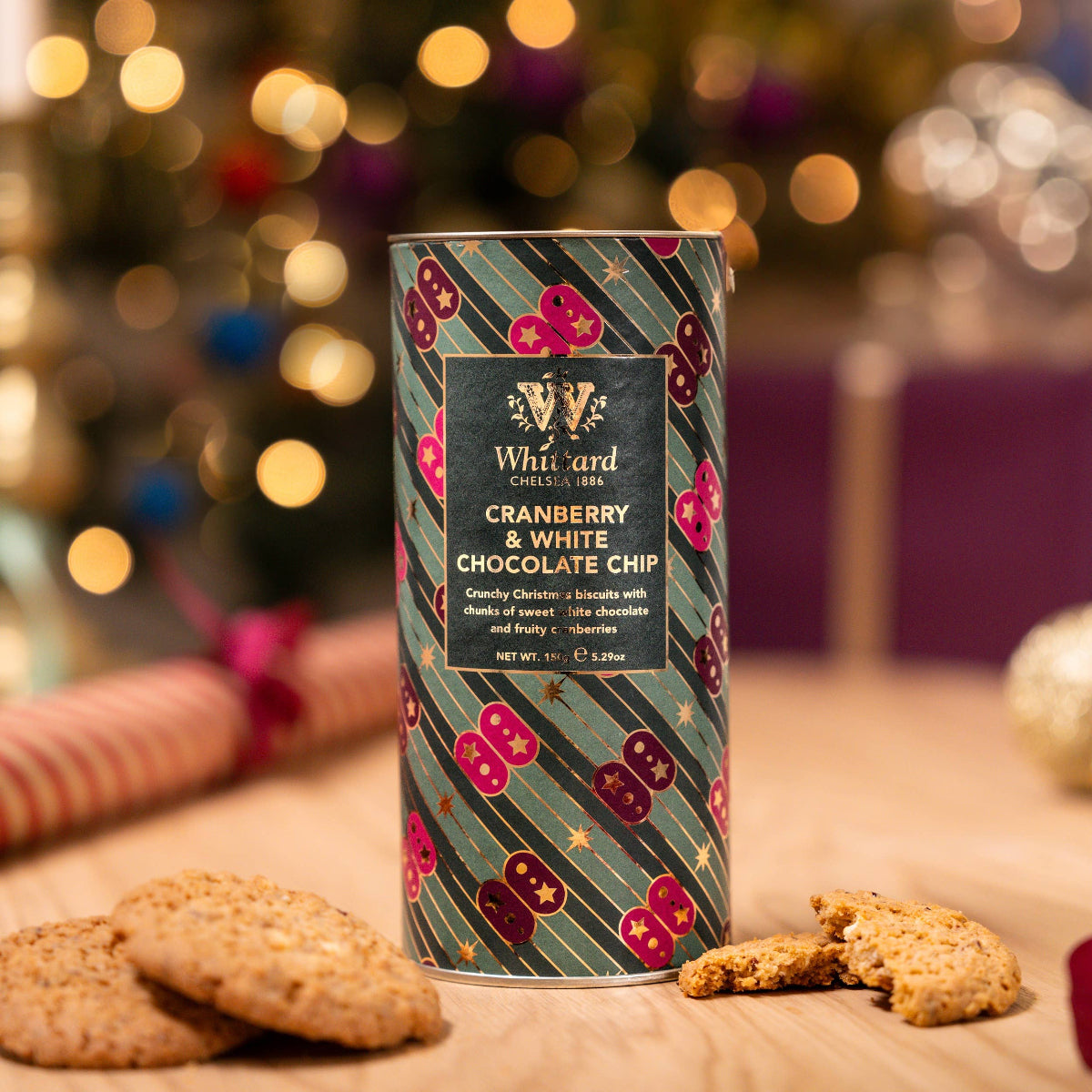 cookies with decorative packaging on a table in front of a blurred festive background