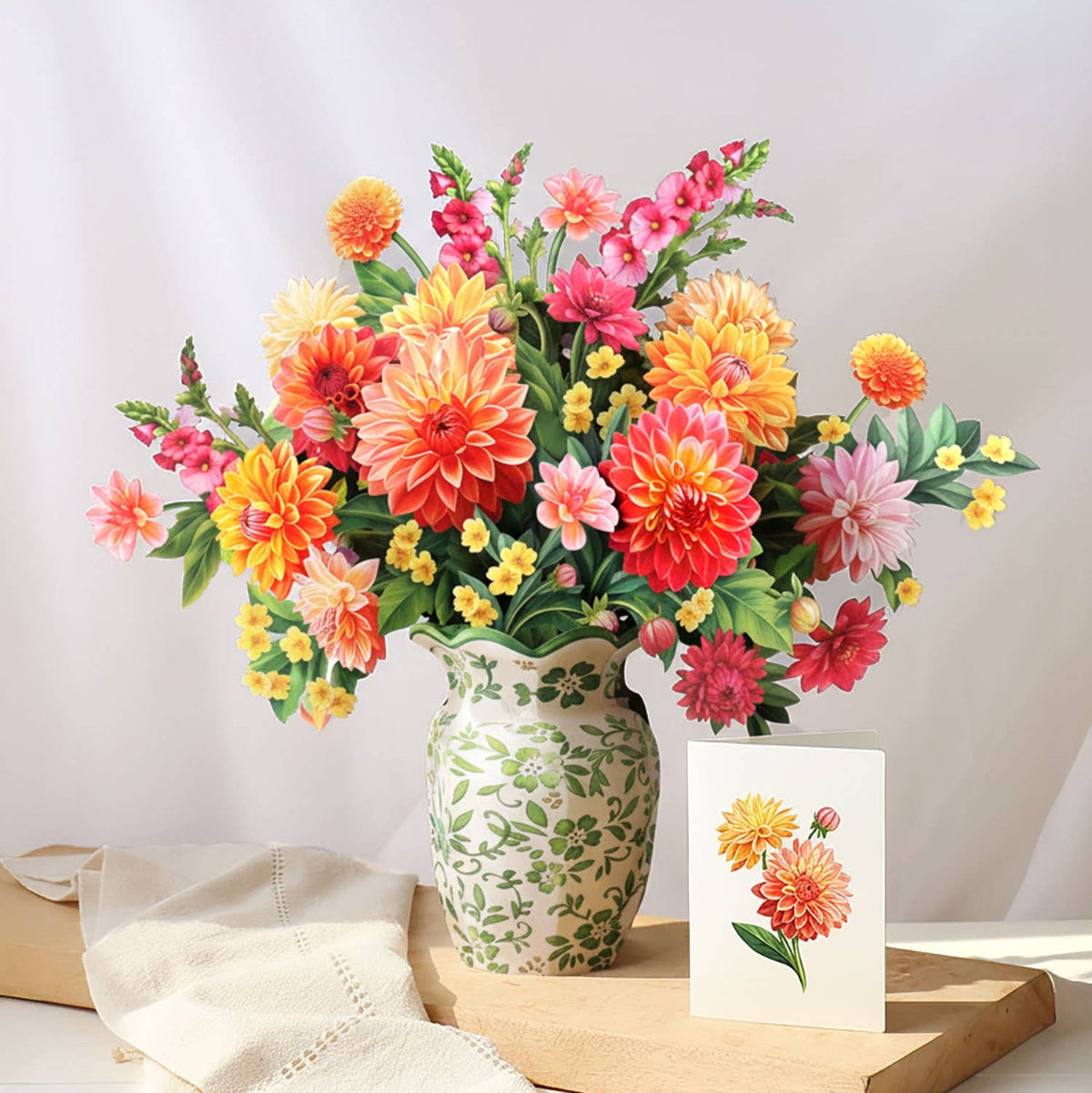 Bouquet of colorful flowers in a vase on a wooden tray with a card on a white background