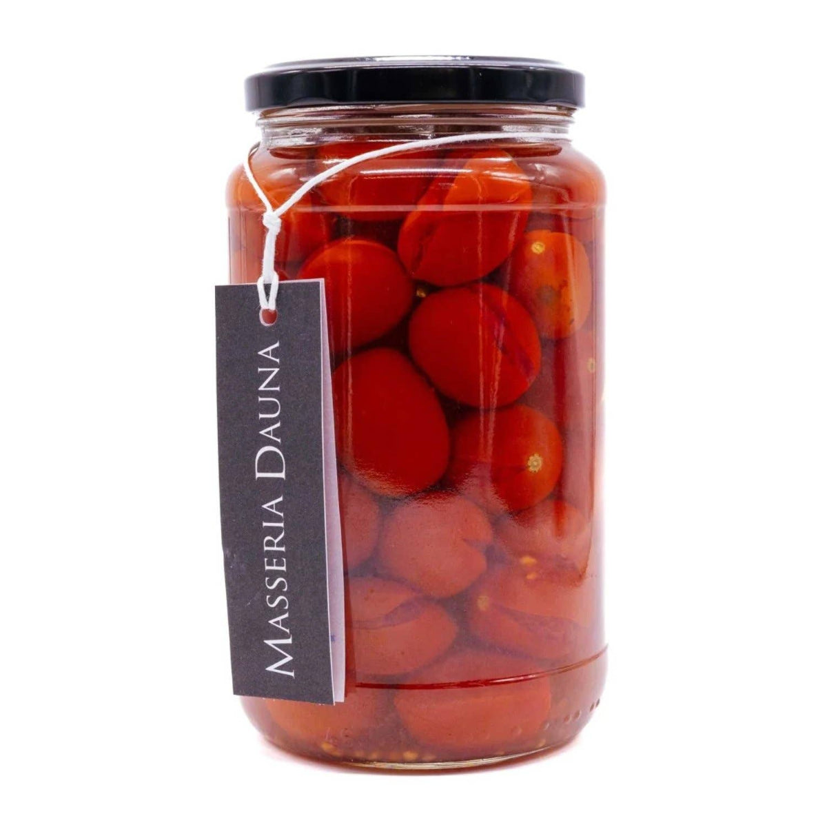 A glass jar of Masseria Dauna sun-dried tomatoes with a black lid and a hanging black label, set against a plain white background.