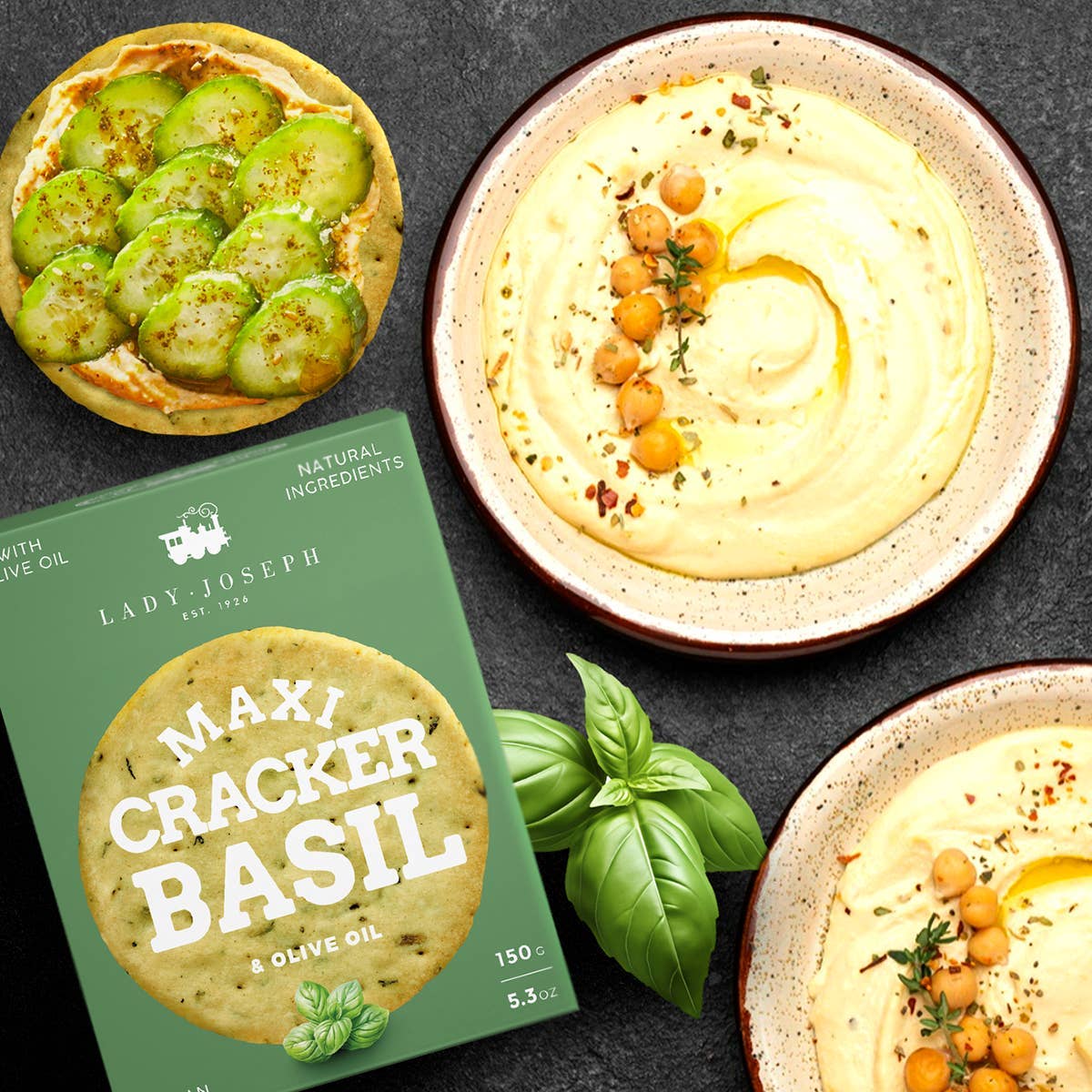 Maxi cracker basil packaging with hummus and vegetables on a dark background