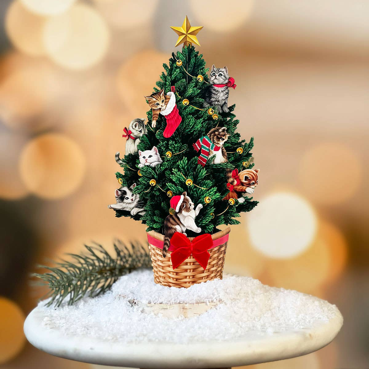 Decorative Christmas tree with small cats and ornaments on a blurred background