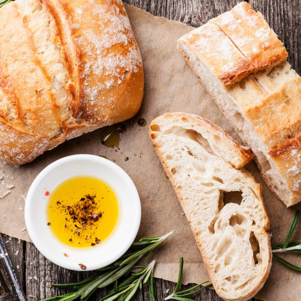 Olive and Basket - olive oils aerial shot with bread and herbs