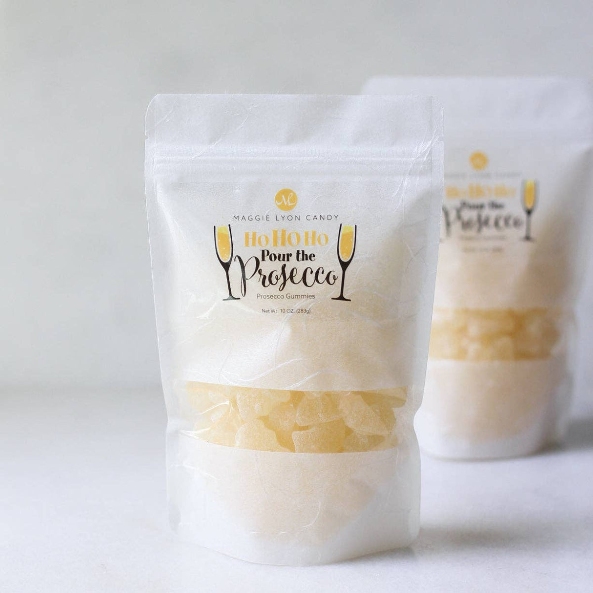 Two packages of 'Pour the Prosecco' candy on a white background