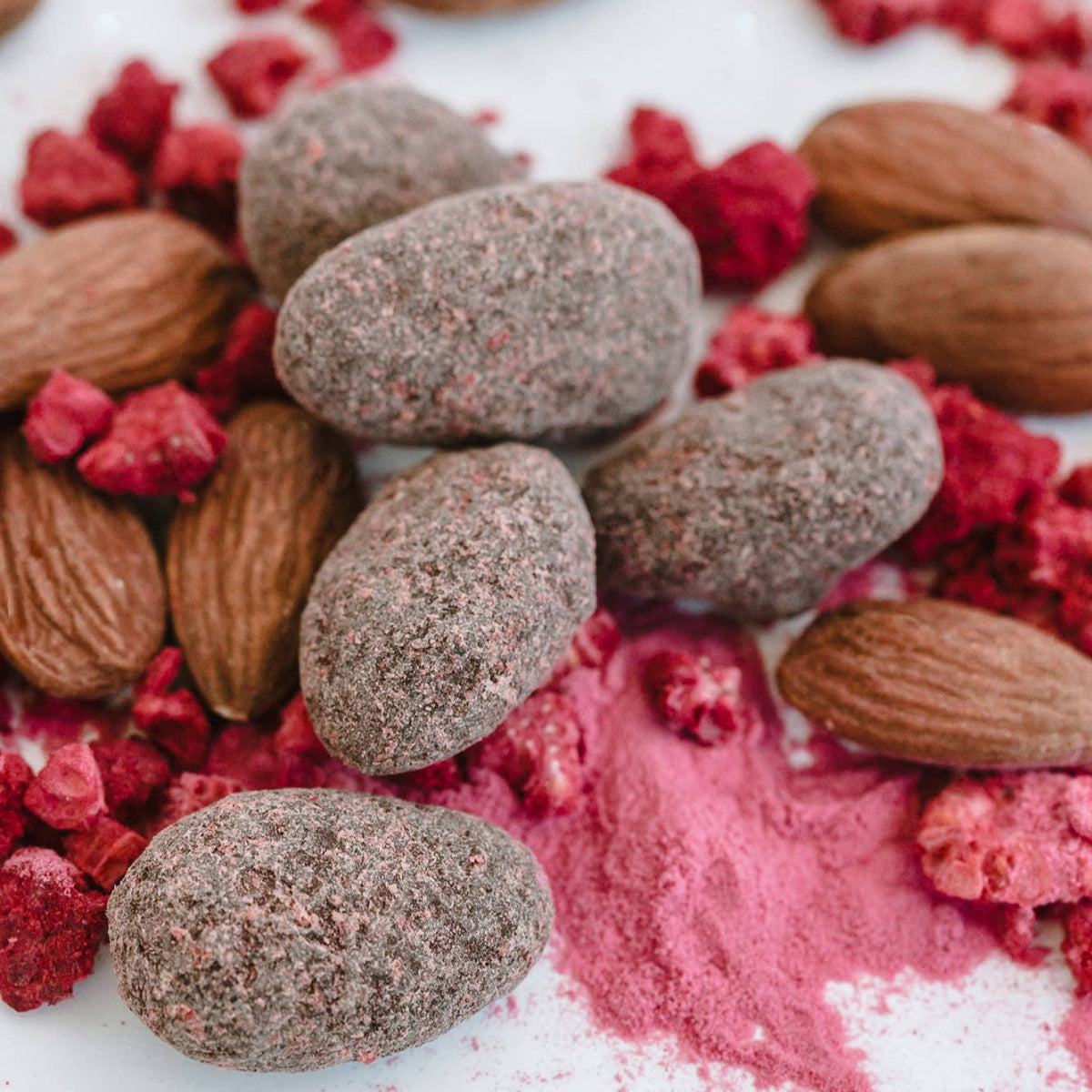 Nuts and dried berries on a white surface