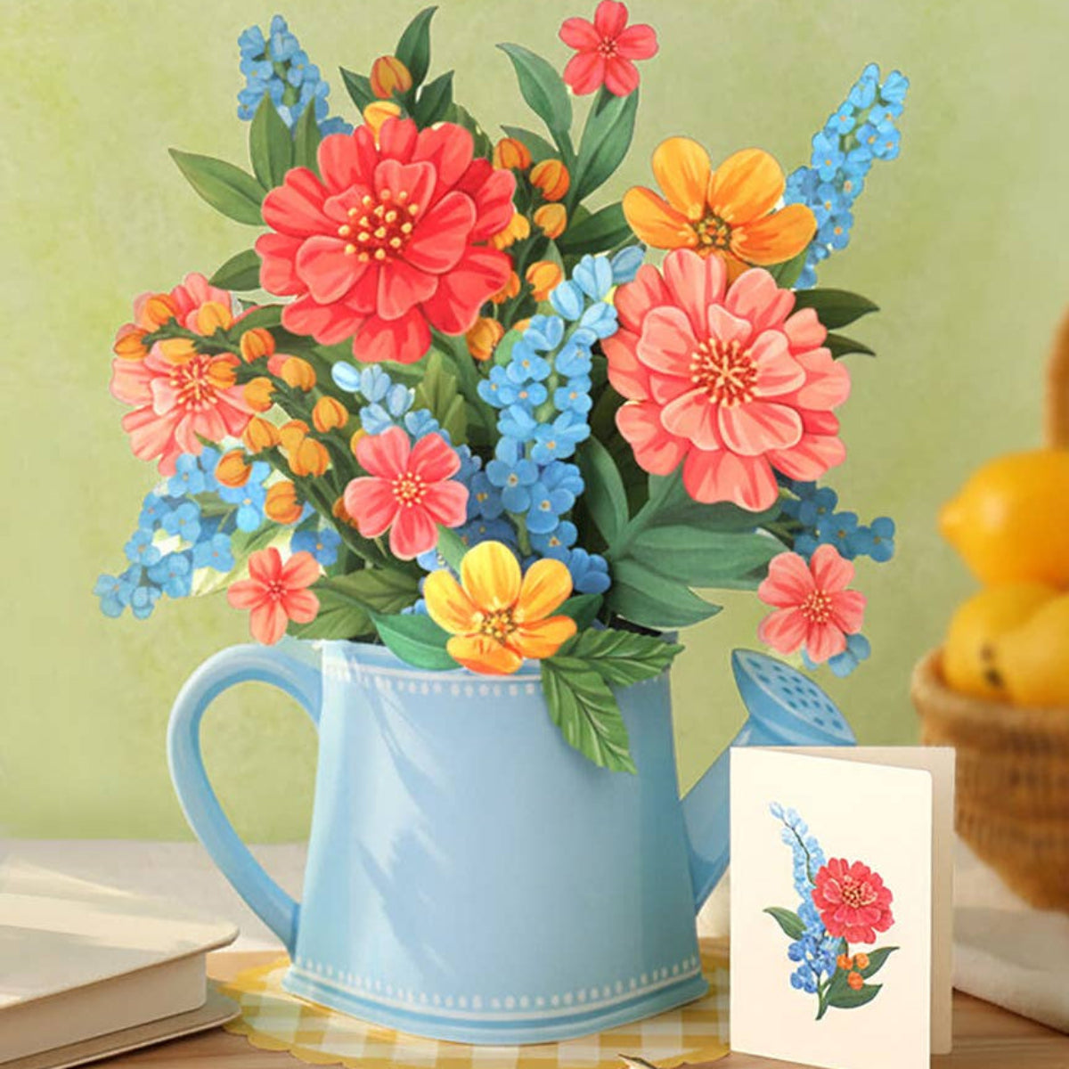 Colorful flowers in a blue mug on a table with a green background
