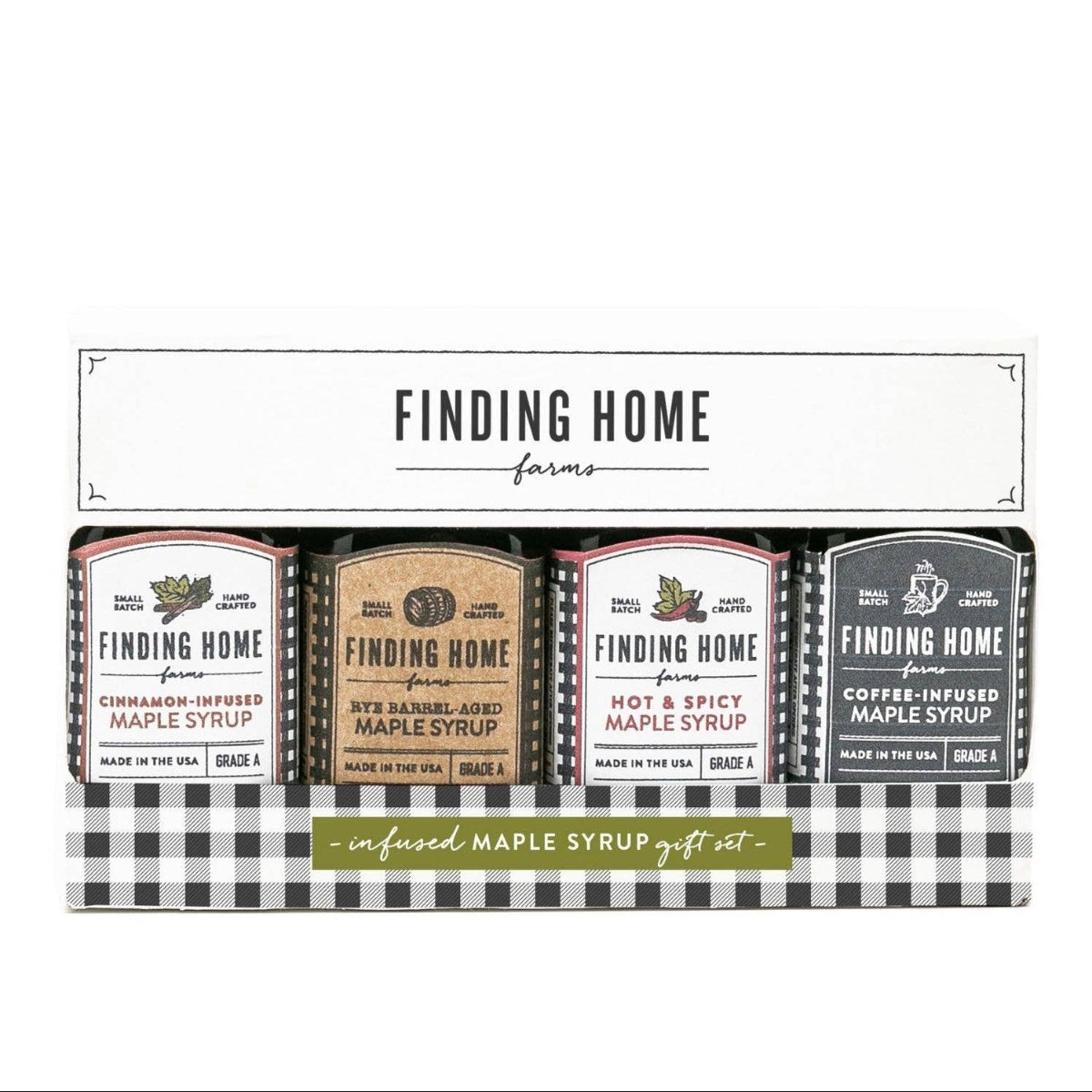 A Finding Home for Me infused maple syrup gift set containing three small bottles of maple syrup in different flavors, presented in a white and black checkered box.
