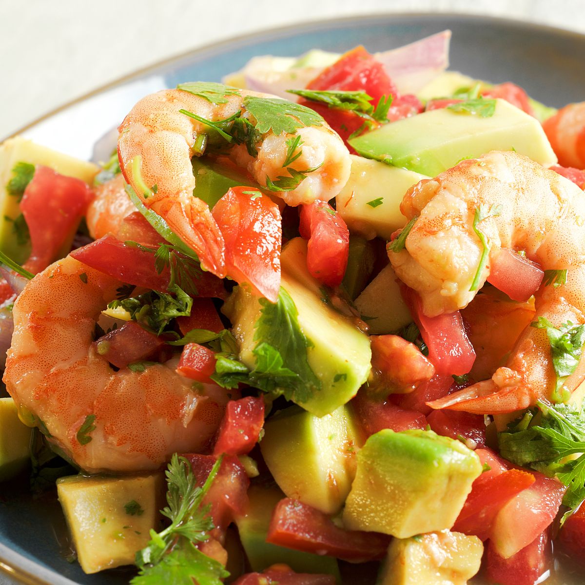 Shrimp salad with avocado and tomatoes on a plate