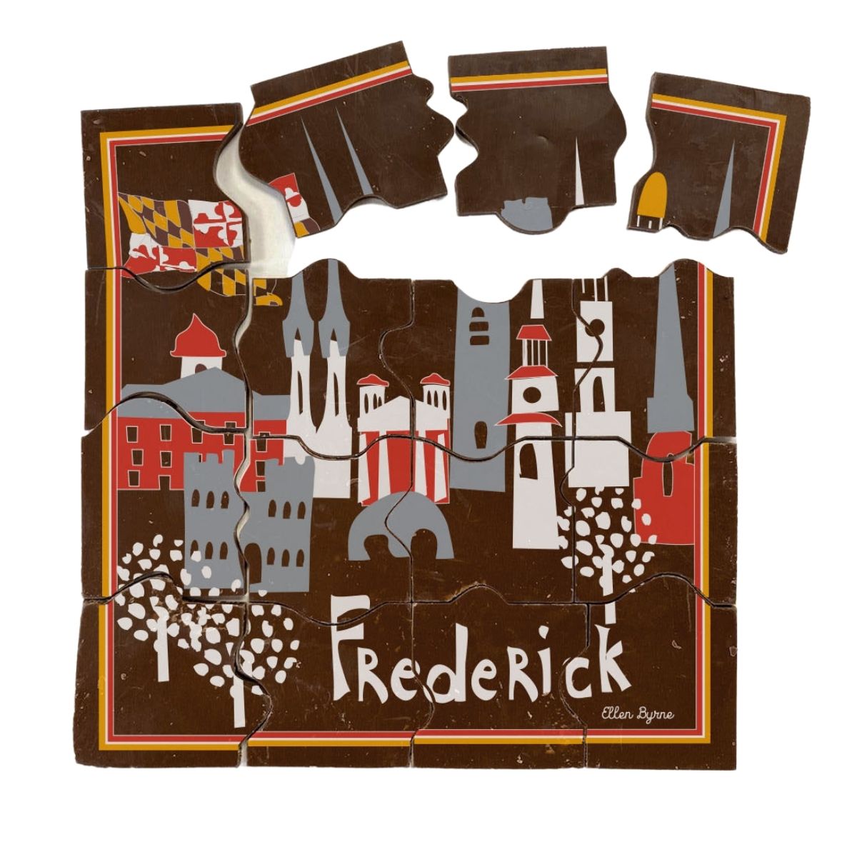 A chocolate puzzle with pieces arranged to form an image related to Frederick city, with buildings and the text &#39;Frederick&#39; on it.